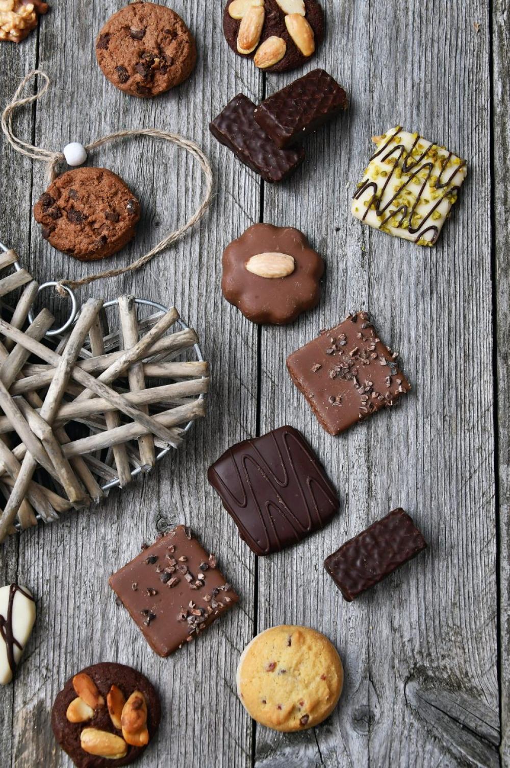 chocolate truffles on old wooden board with hearts chocolate truffles on old wooden board with hearts