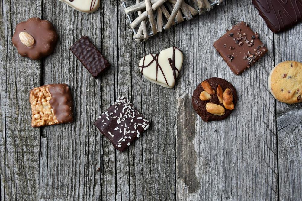 chocolate truffles on old wooden board with hearts chocolate truffles on old wooden board with hearts
