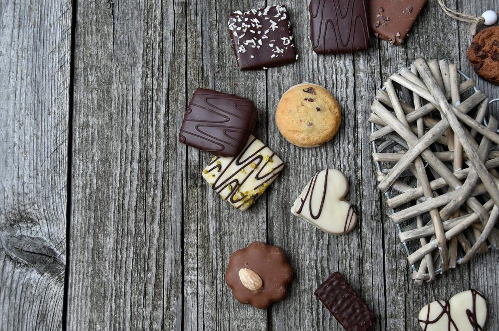 chocolate truffles on old wooden board with hearts chocolate truffles on old wooden board with hearts