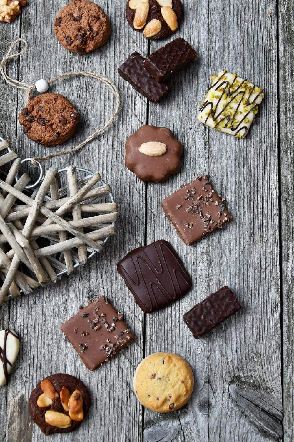 chocolate truffles on old wooden board with hearts chocolate truffles on old wooden board with hearts