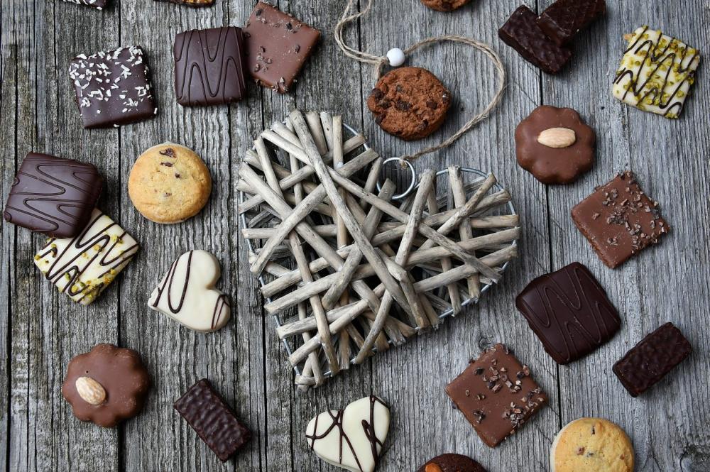 chocolate truffles on old wooden board with hearts chocolate truffles on old wooden board with hearts