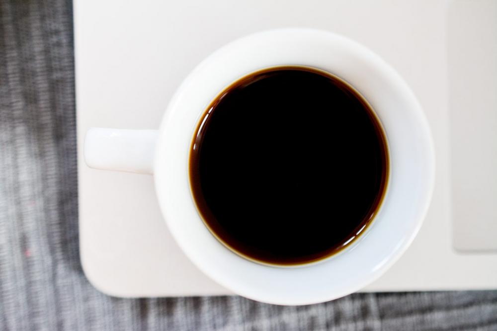 Black coffee on macbook from the top Black coffee on macbook from the top