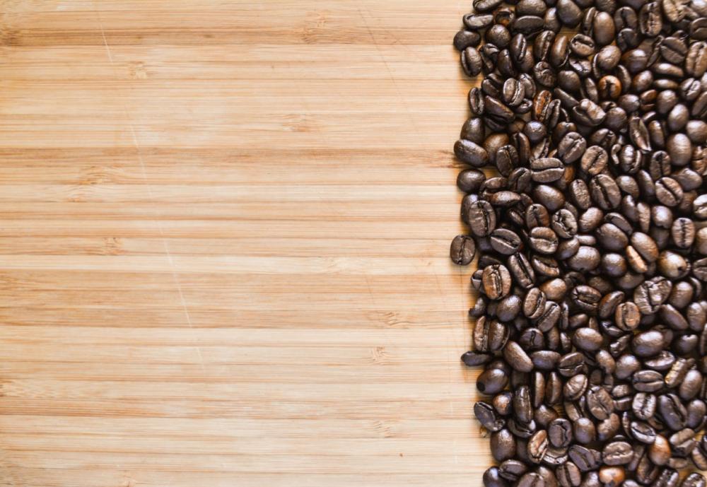 Coffee beans on right side on wood Coffee beans on right side on wood