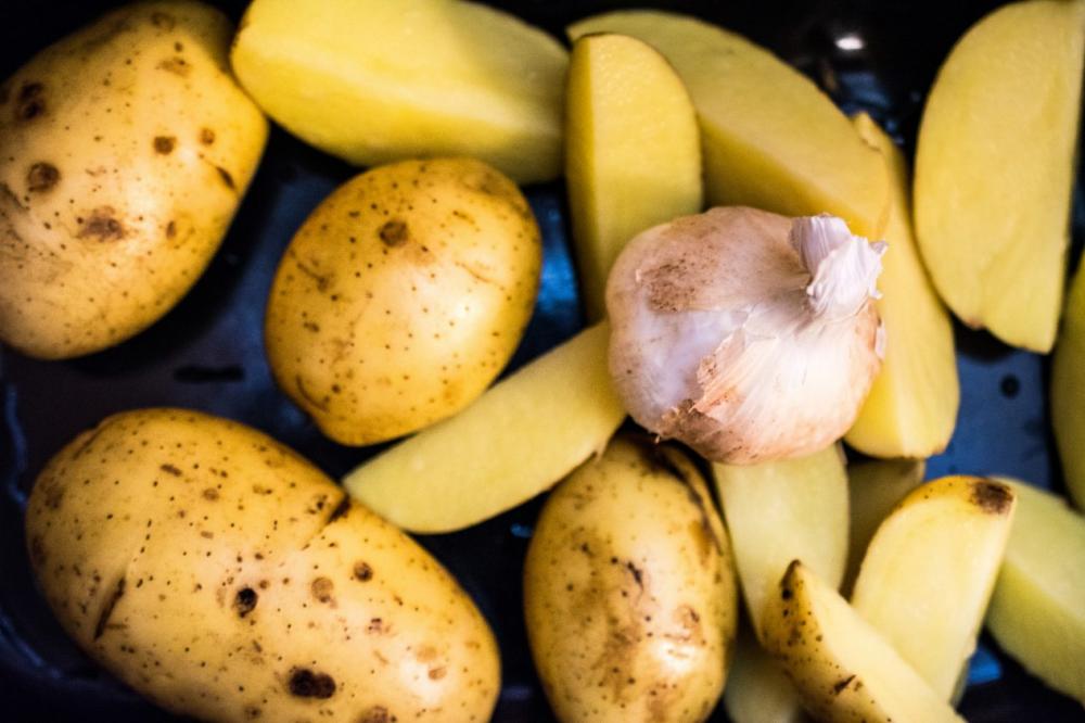 Garlic on fresh potatoes top view Garlic on fresh potatoes top view
