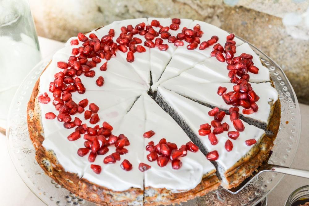 Poppy cake with pomegranate on glass plate Poppy cake with pomegranate on glass plate