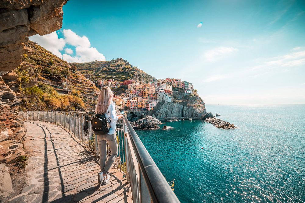 Young Traveler Admires Beautiful Manarola Town, Italy Young Traveler Admires Beautiful Manarola Town, Italy