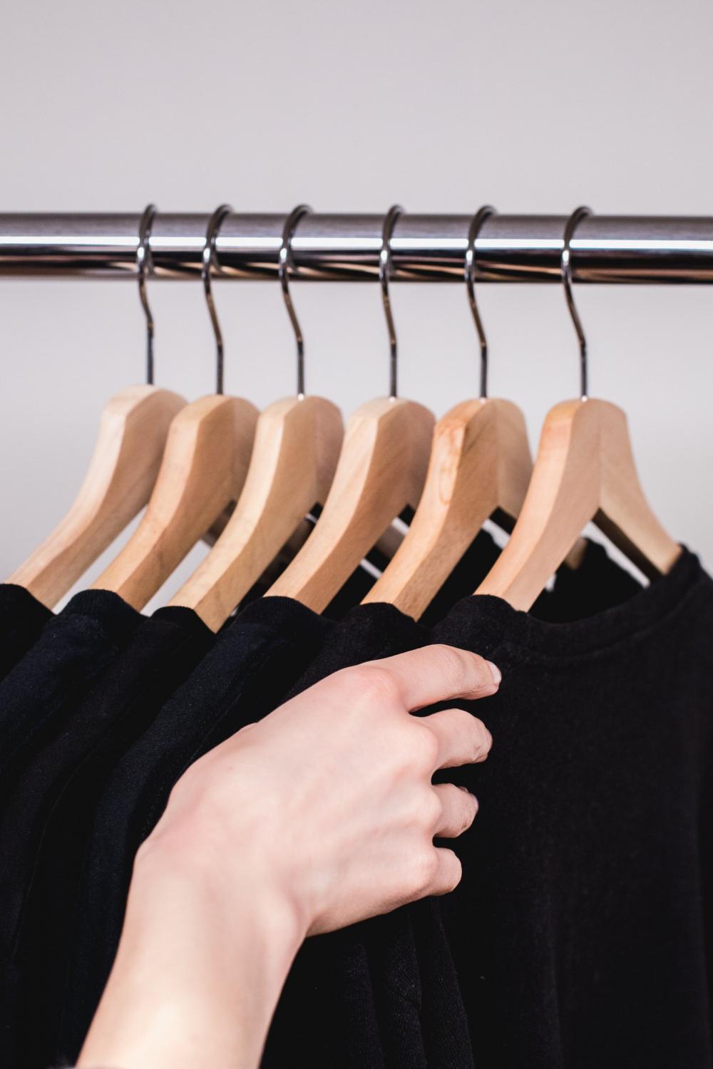 Hand Reaches For Hanging Sweatshirt Photo Hand Reaches For Hanging Sweatshirt Photo