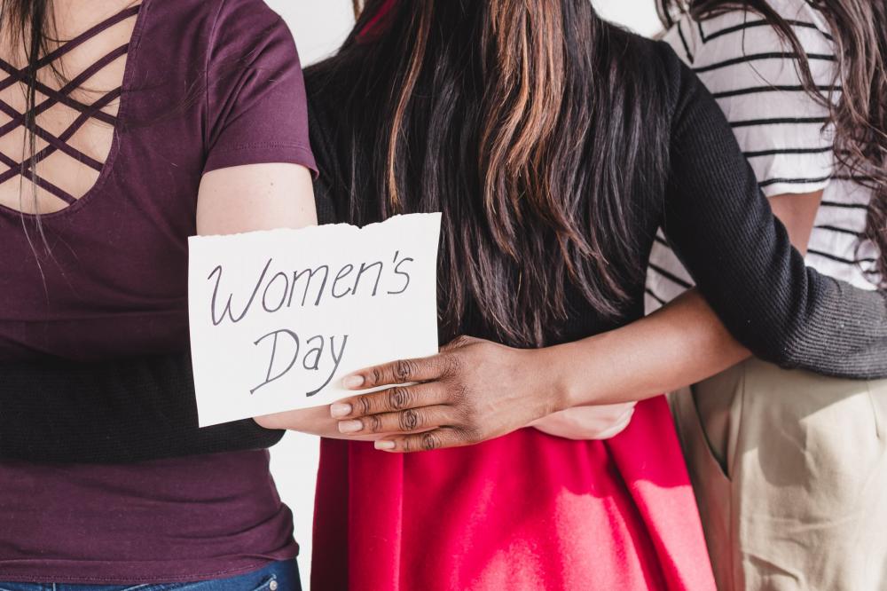 Women Linking Arms In Celebration Of Women's Day Photo Women Linking Arms In Celebration Of Women's Day Photo