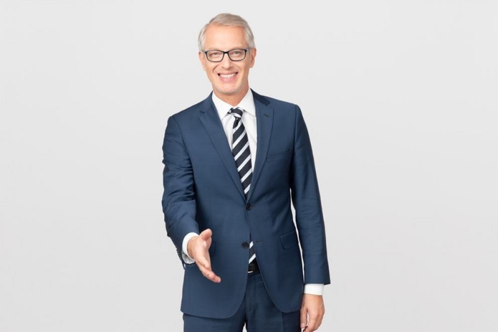 Middle Aged Businessman Giving A Hand And Welcoming Middle Aged Businessman Giving A Hand And Welcoming