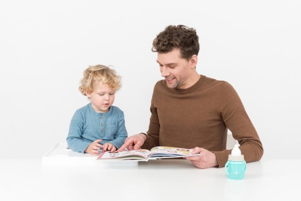 Father Reading A Book Together With His Baby Boy Son Father Reading A Book Together With His Baby Boy Son