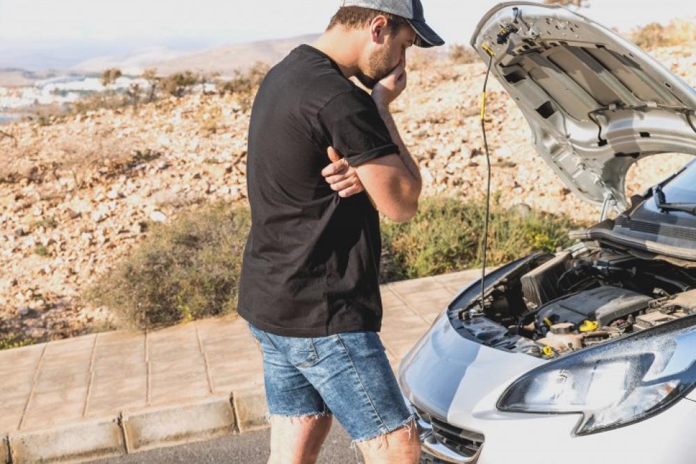 Man looking at engine of car Man looking at engine of car