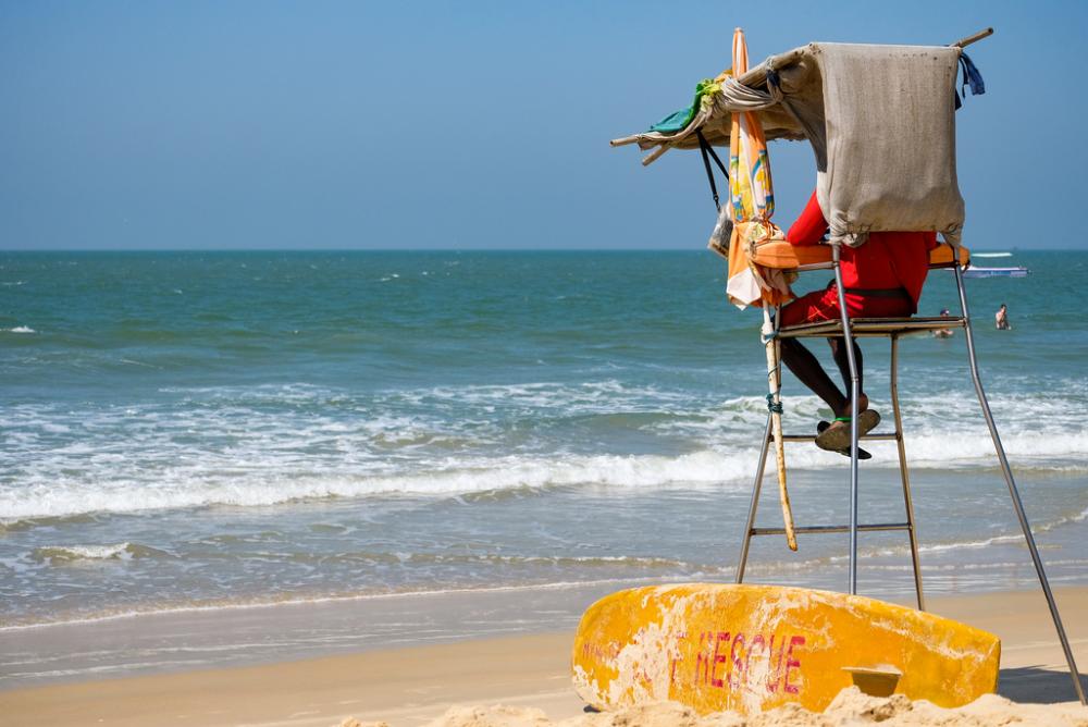 Lifeguard Sitting on Surveillance Tower Observing the Sea Lifeguard Sitting on Surveillance Tower Observing the Sea
