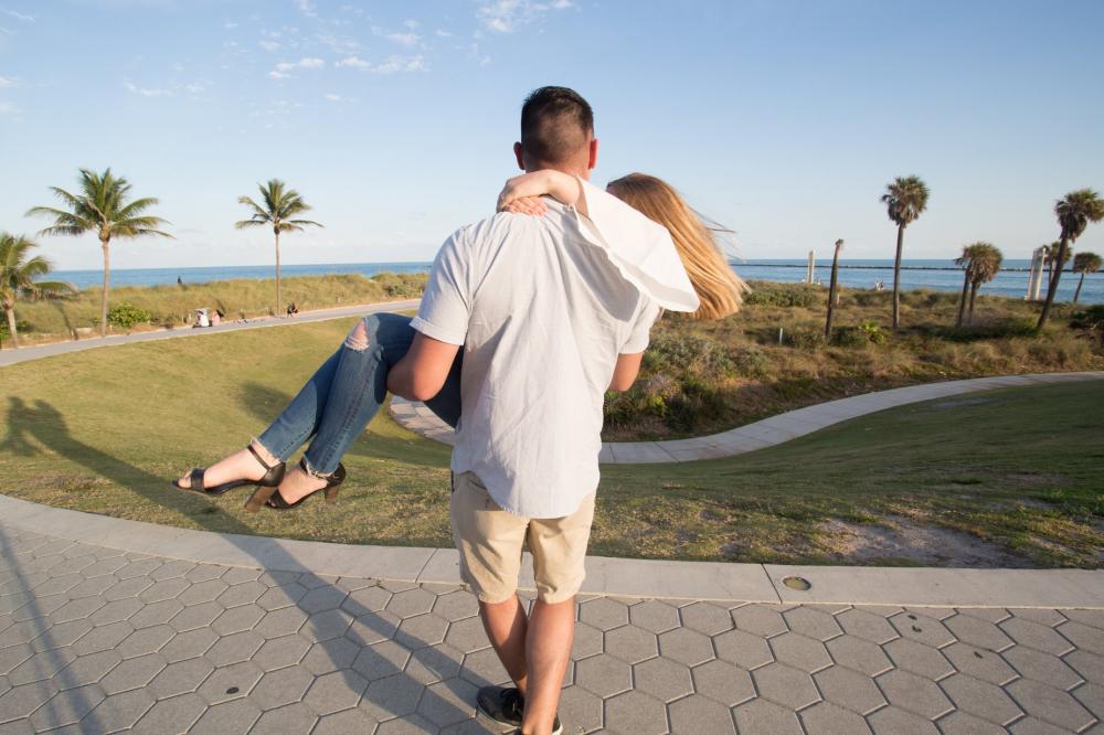 Man Carries Woman In Park Photo Man Carries Woman In Park Photo