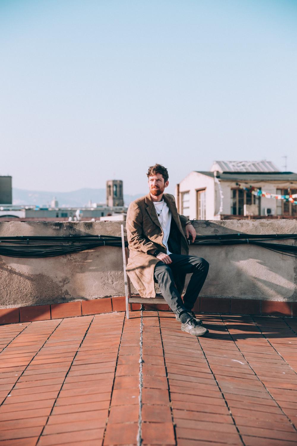 Man Sits On Chair On Roof Photo Man Sits On Chair On Roof Photo