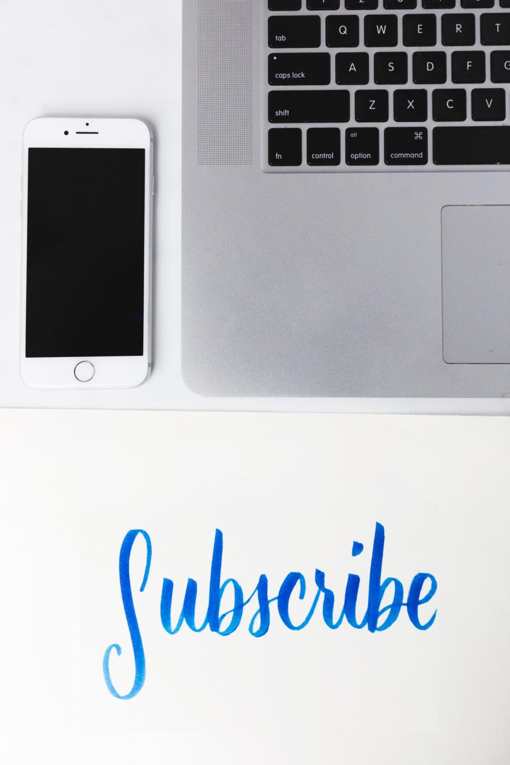 Subscribe Written Under A Phone And Laptop Photo Subscribe Written Under A Phone And Laptop Photo