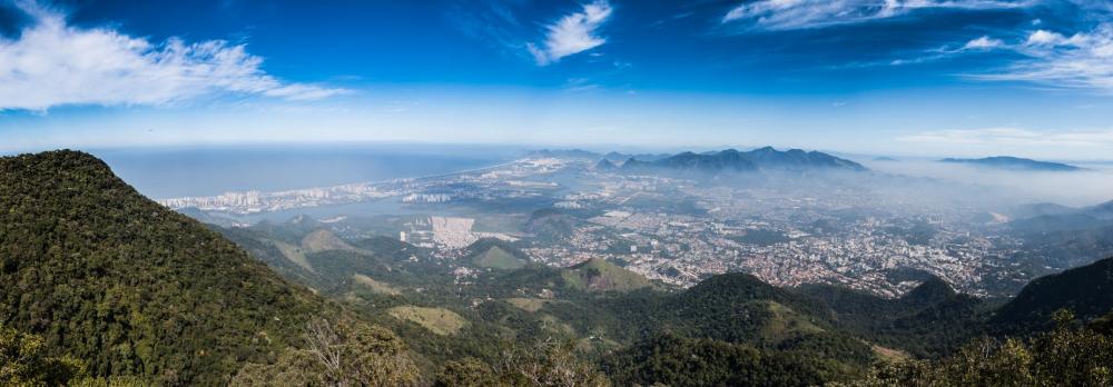 A Misty City Nestled Between Mountains On A Sunny Day Photo A Misty City Nestled Between Mountains On A Sunny Day Photo