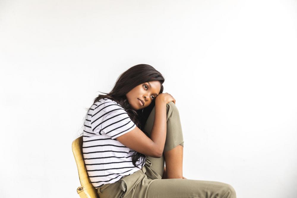 A Woman Rests Head On Knee And Stares Thoughtfully Photo A Woman Rests Head On Knee And Stares Thoughtfully Photo