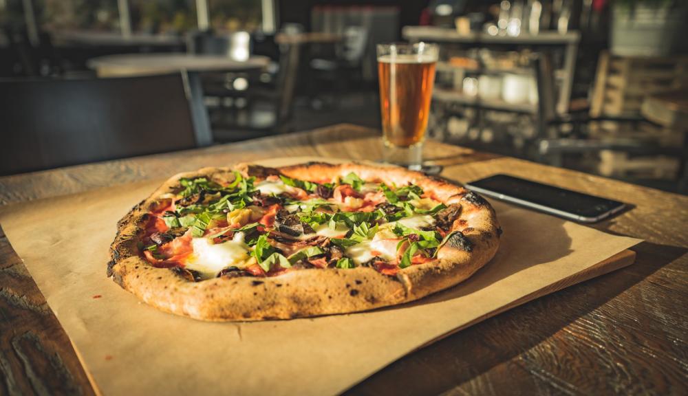 Dinner For One Of Wood Fired Pizza Paired With Cold Beer Photo Dinner For One Of Wood Fired Pizza Paired With Cold Beer Photo