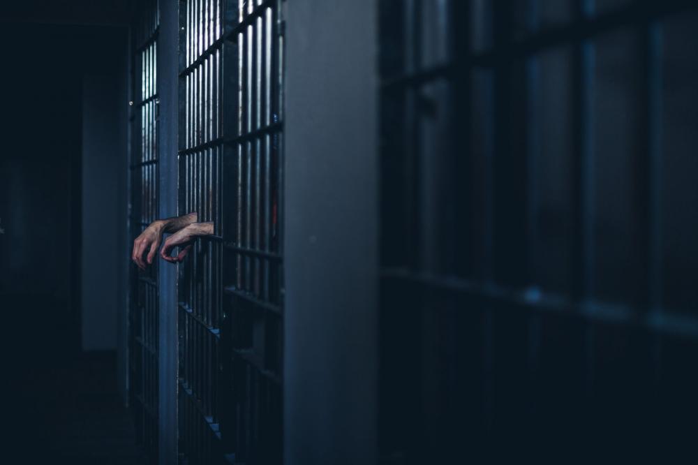 Hand Through Cell Bars Photo Hand Through Cell Bars Photo