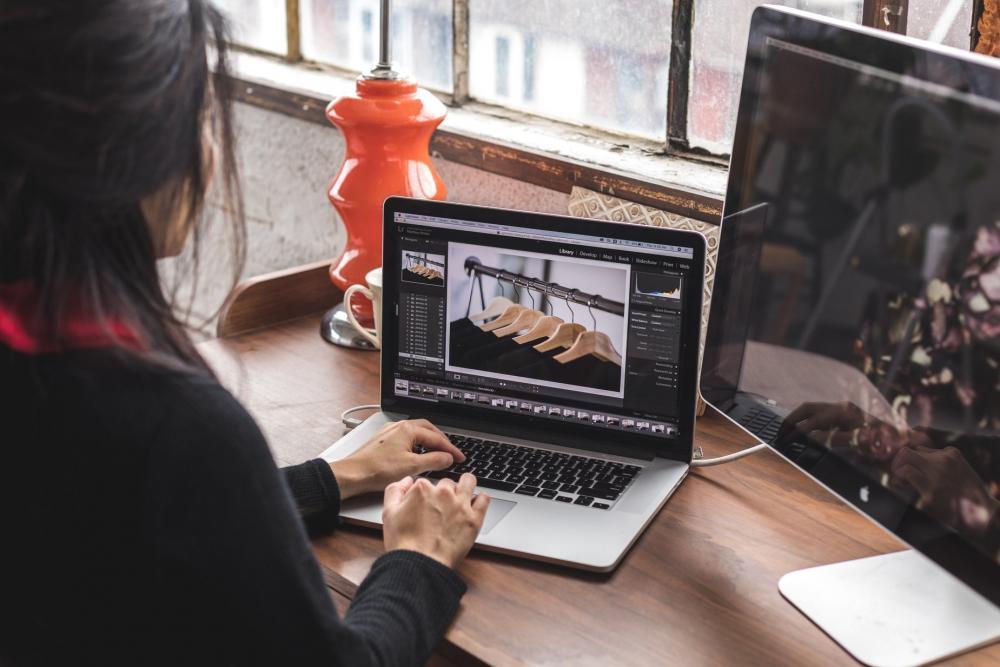 Woman Edits Images On Her Laptop Photo Woman Edits Images On Her Laptop Photo