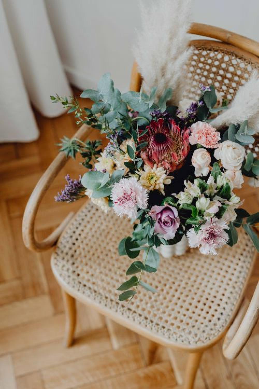 Beautiful bouquet of flowers on a wooden chair Beautiful bouquet of flowers on a wooden chair