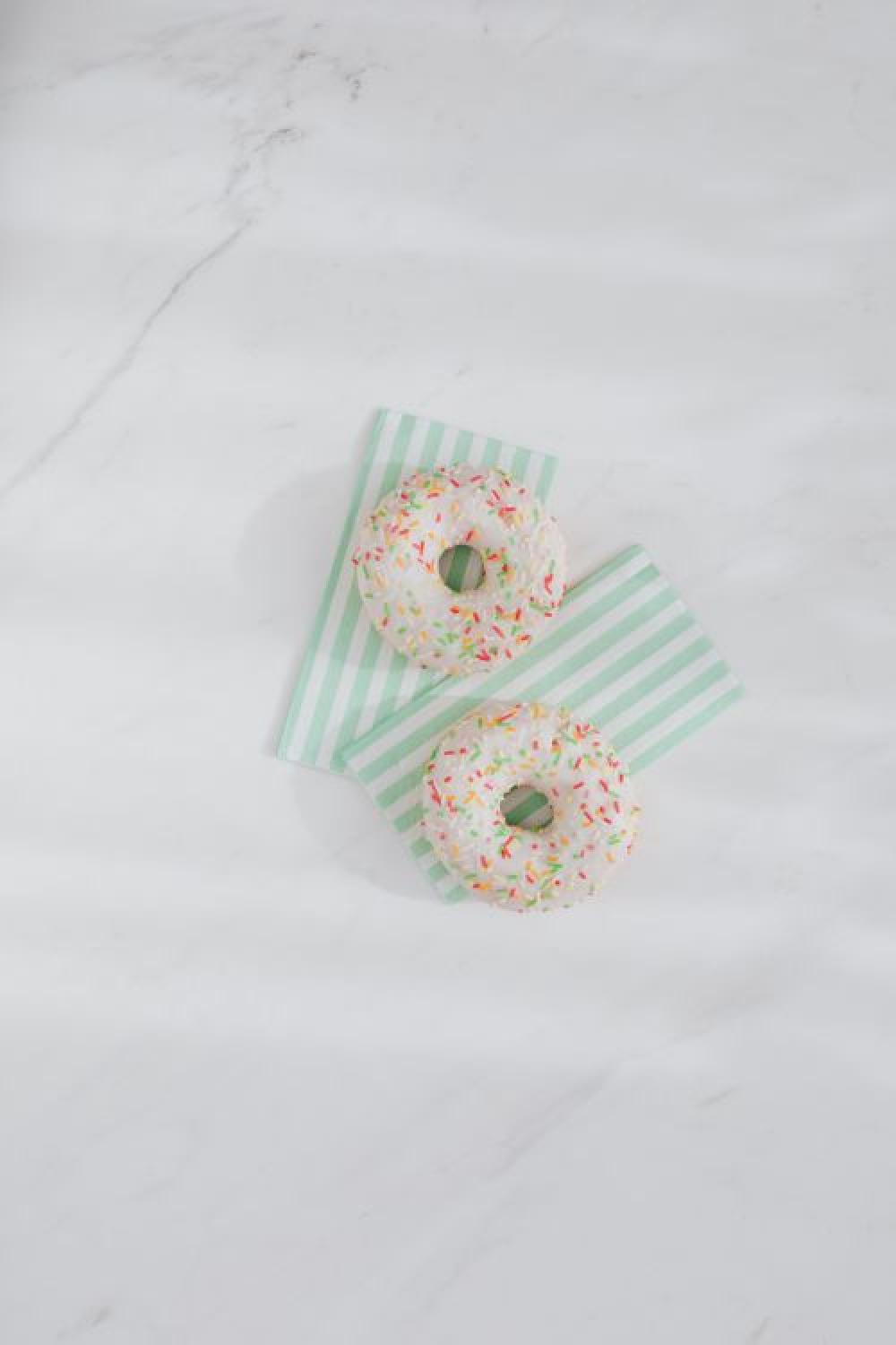 Donuts on paper napkins placed on white marble Donuts on paper napkins placed on white marble