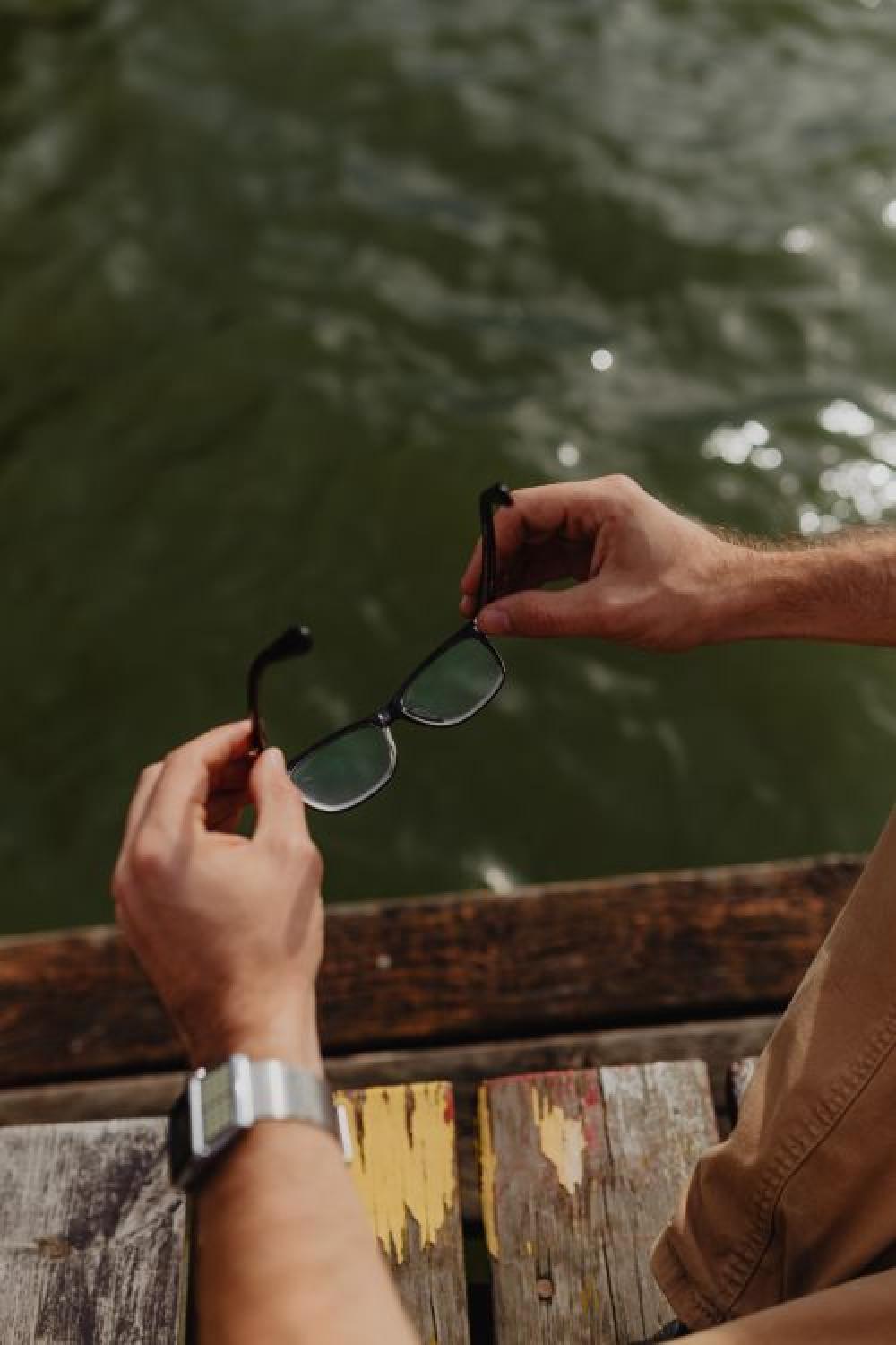 Closeup of glasses & vinatage watch on wrist of man Closeup of glasses & vinatage watch on wrist of man