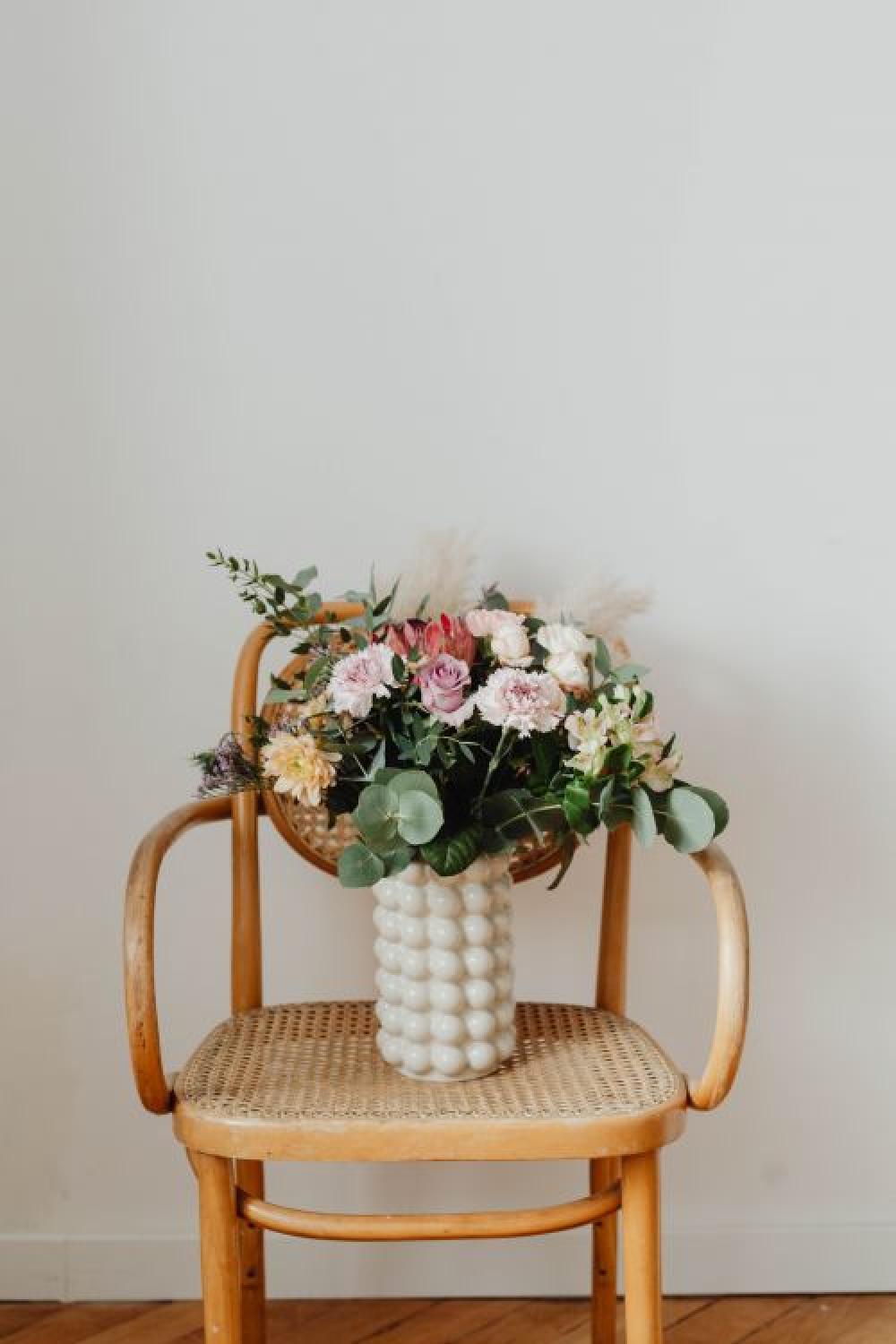 Beautiful bouquet of flowers on a wooden chair Beautiful bouquet of flowers on a wooden chair
