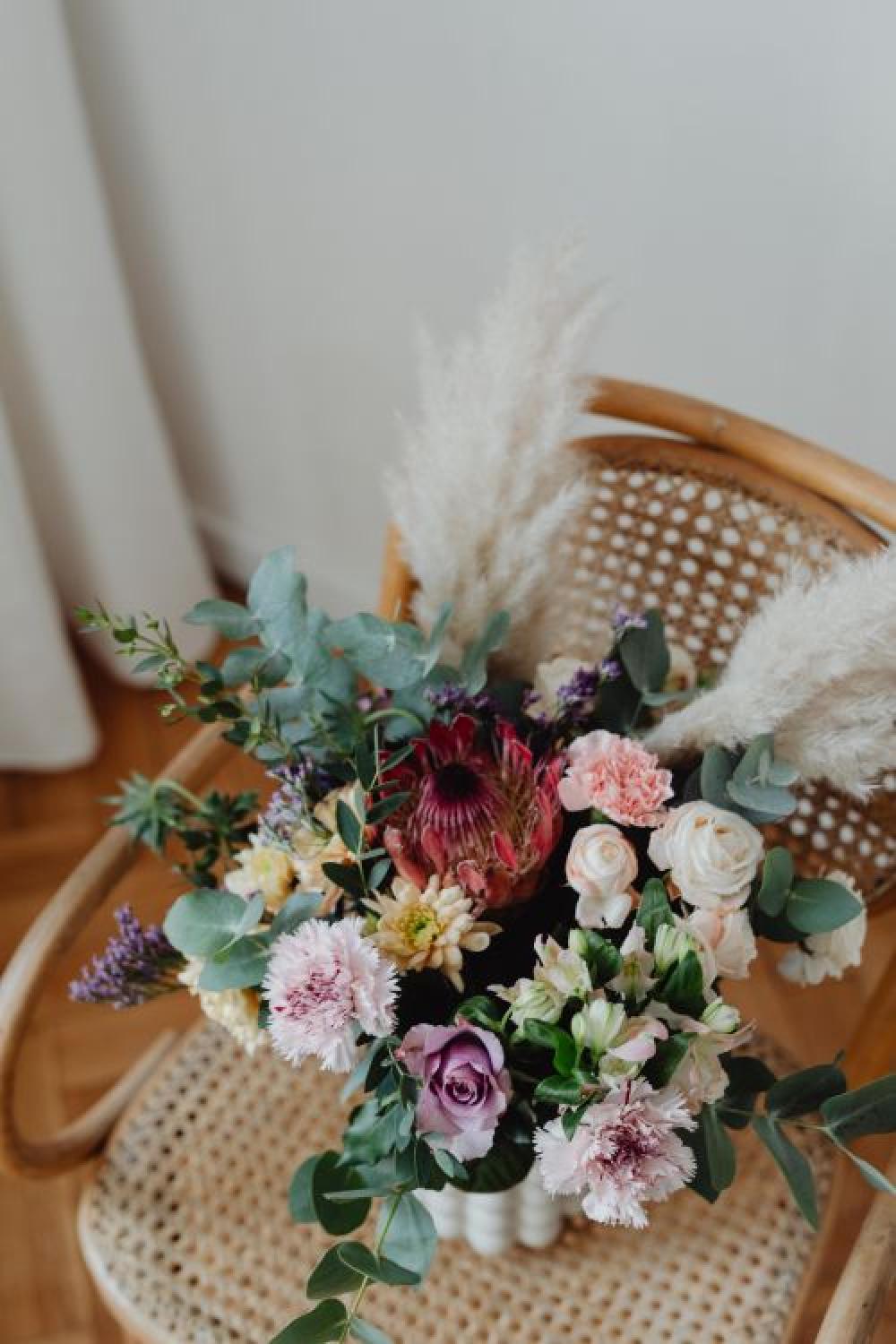 Beautiful bouquet of flowers on a wooden chair Beautiful bouquet of flowers on a wooden chair