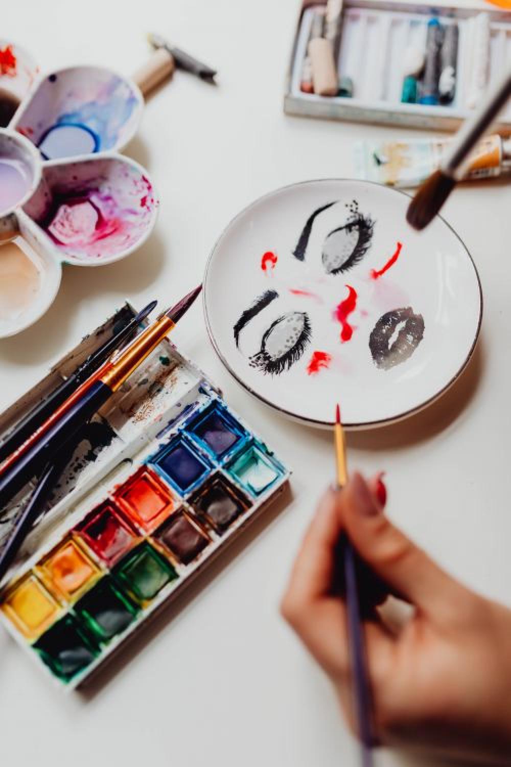 A woman paints with watercolors A woman paints with watercolors
