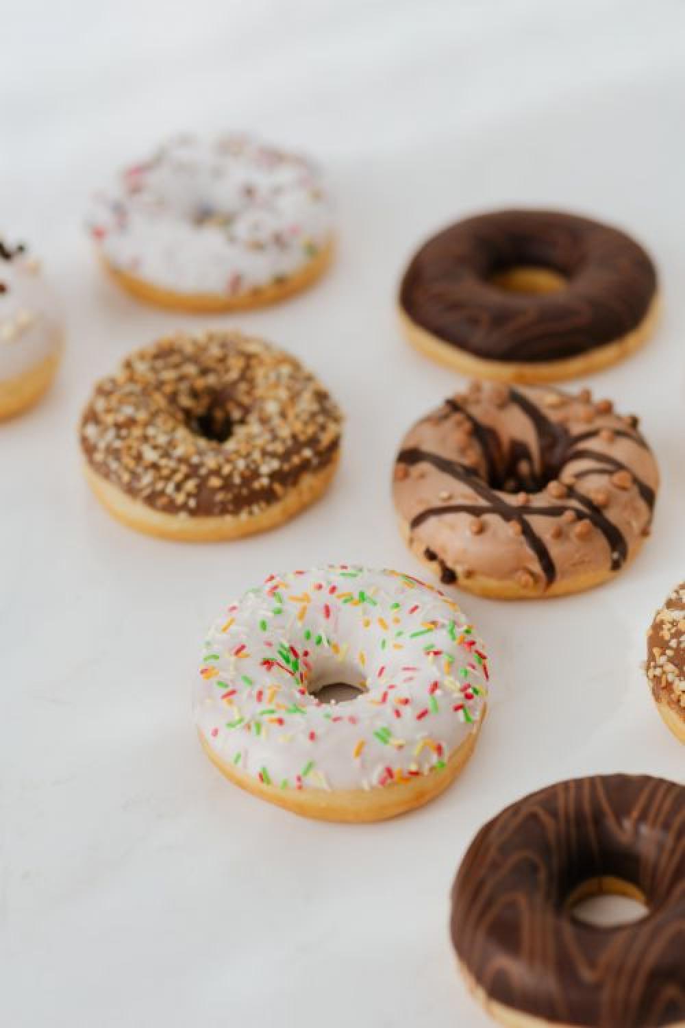 Various donuts on white marble Various donuts on white marble