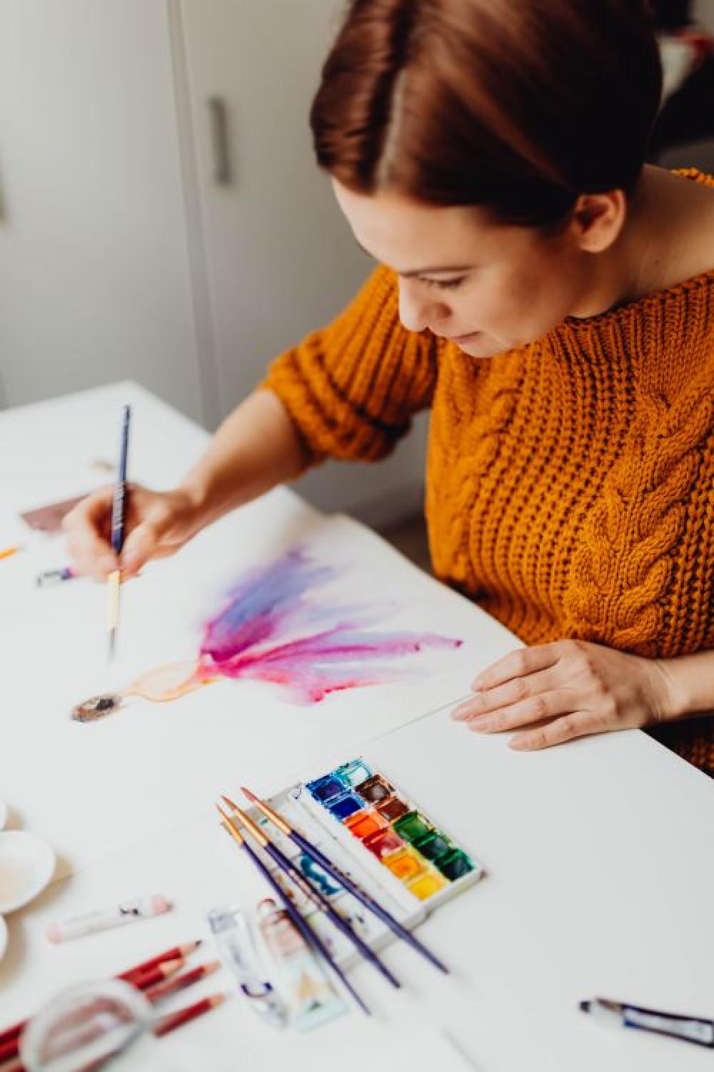 A woman paints with watercolors A woman paints with watercolors
