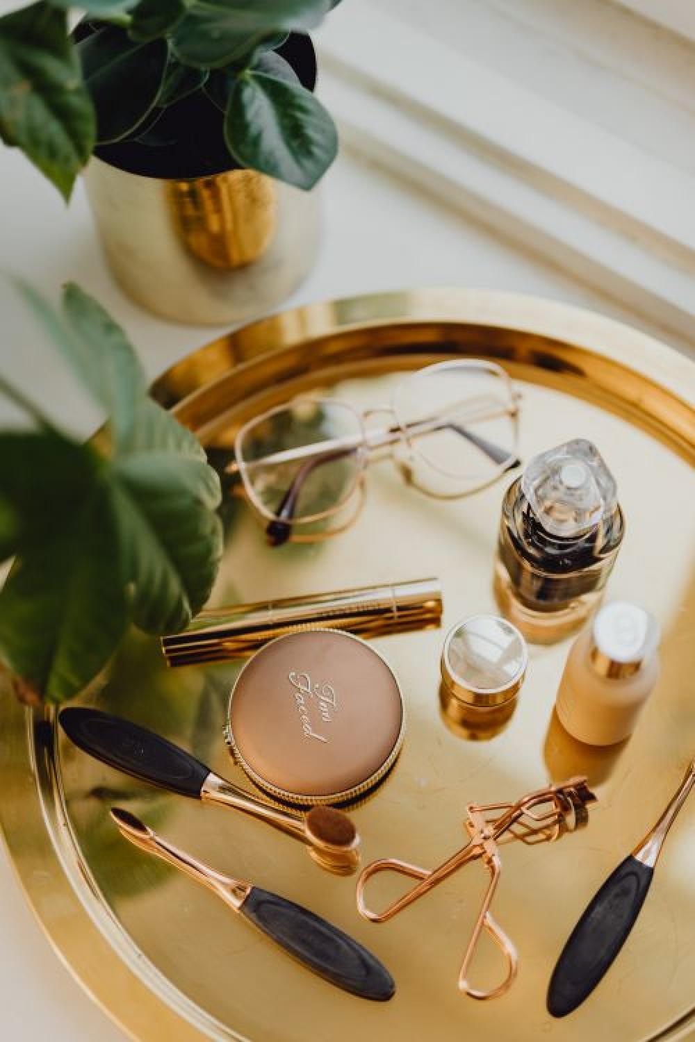 Makeup essentials on a golden tray Makeup essentials on a golden tray