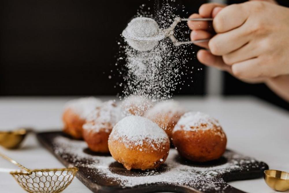 Homemade doughnuts covered with powdered sugar. Fat Thursday in Poland. Homemade doughnuts covered with powdered sugar. Fat Thursday in Poland.