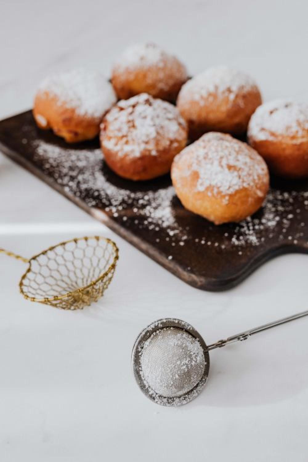 Homemade doughnuts covered with powdered sugar. Fat Thursday in Poland. Homemade doughnuts covered with powdered sugar. Fat Thursday in Poland.