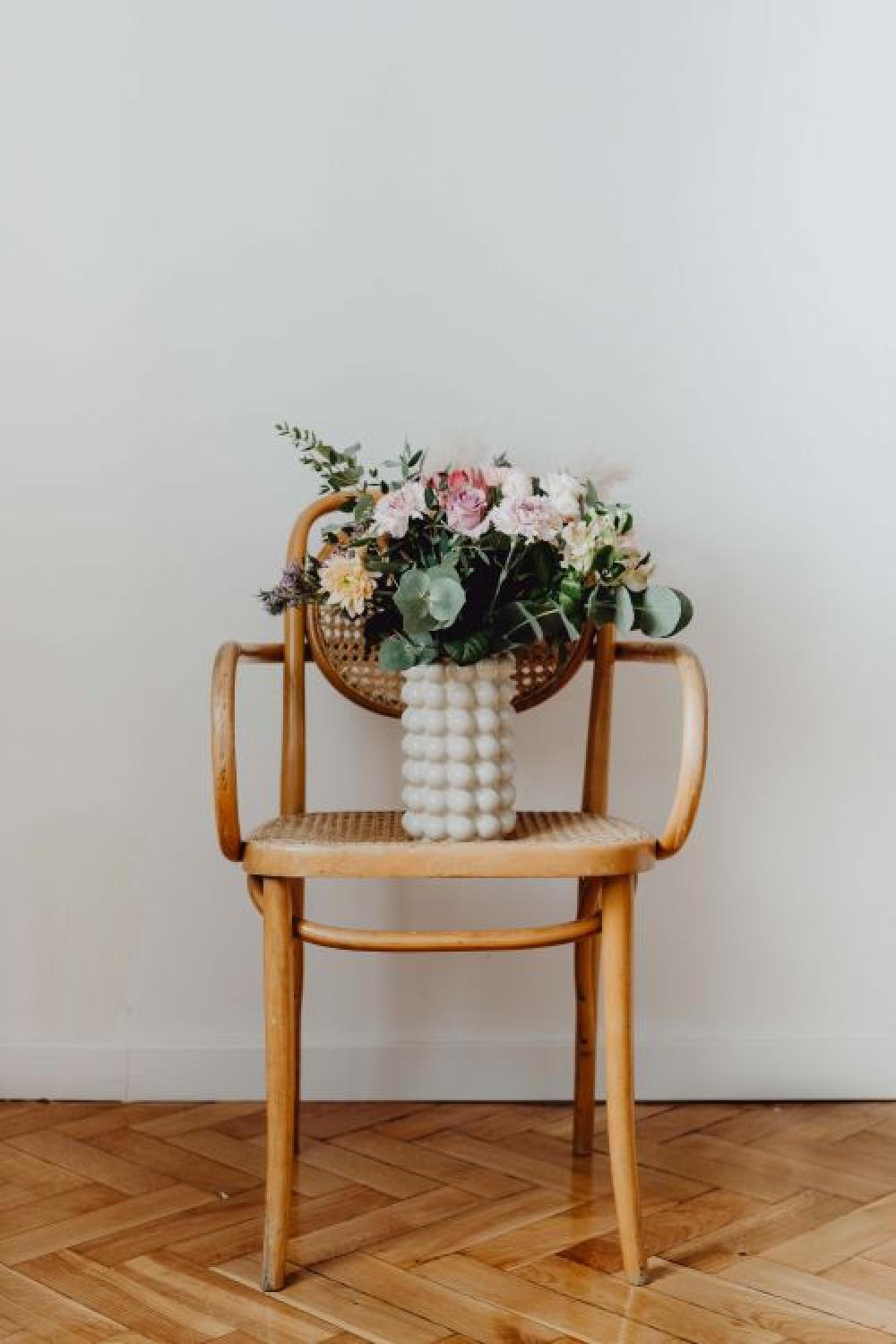 Beautiful bouquet of flowers on a wooden chair Beautiful bouquet of flowers on a wooden chair