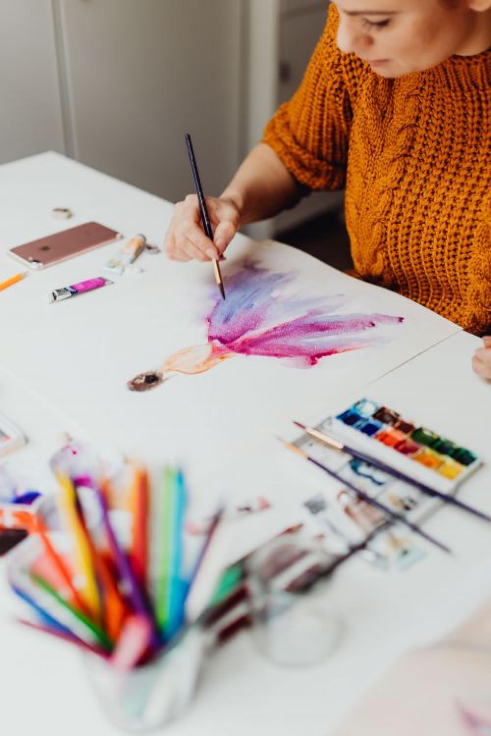 A woman paints with watercolors A woman paints with watercolors