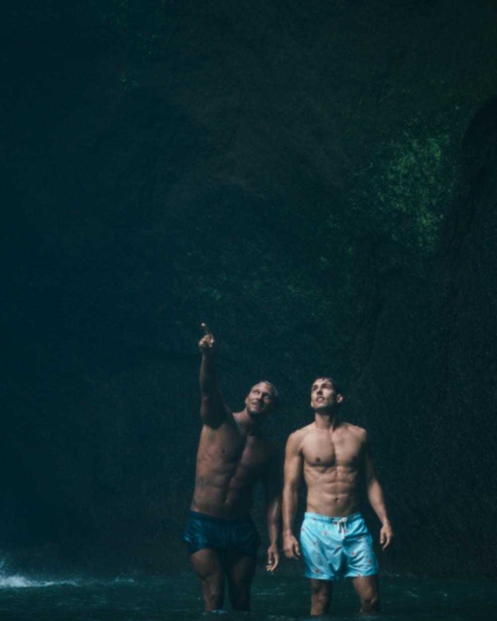 two men swimming pointing dark two men swimming pointing dark