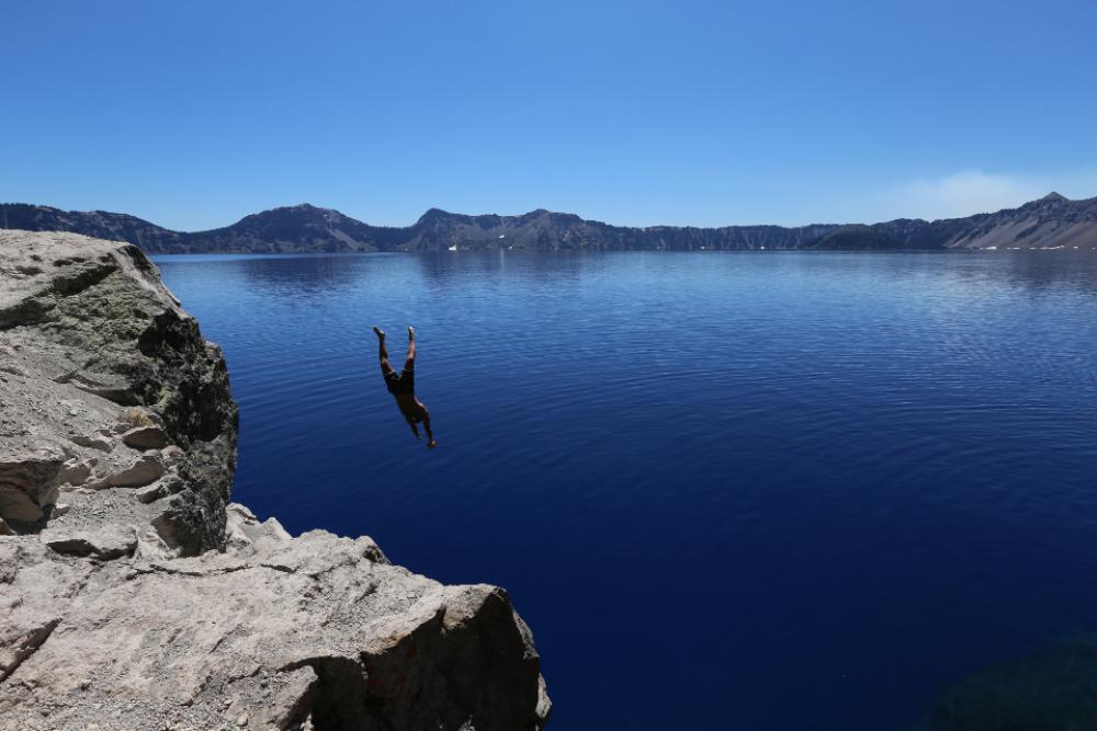 man diving lake water cold man diving lake water cold
