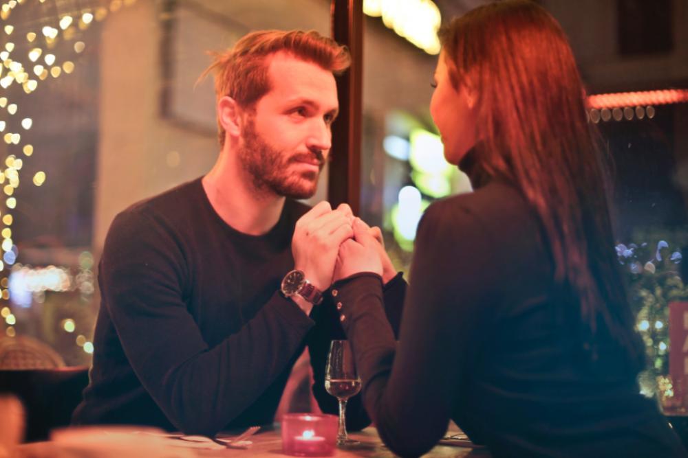 romantic dinner couple holding hands romantic dinner couple holding hands
