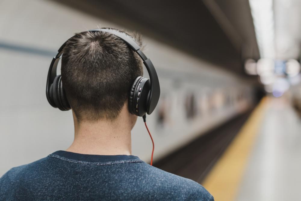 man walking train station headphones man walking train station headphones