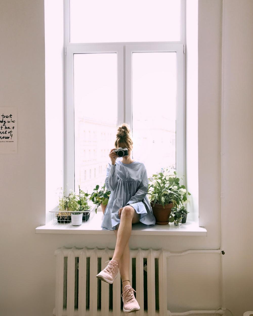 woman crossed legs window sill woman crossed legs window sill