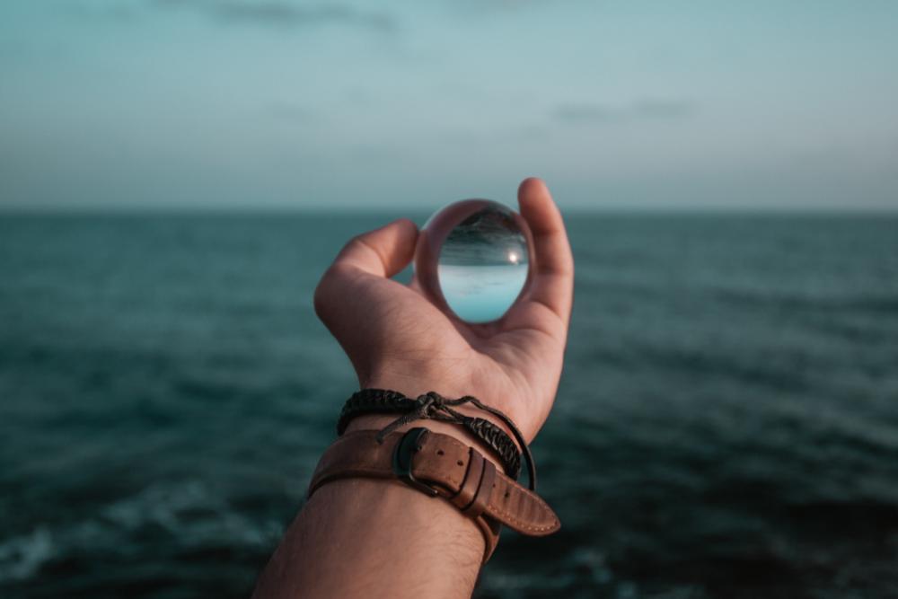 man holding glass globe watch man holding glass globe watch