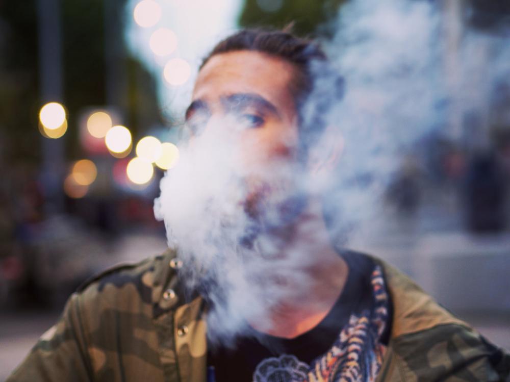 man smoking street city bokeh man smoking street city bokeh