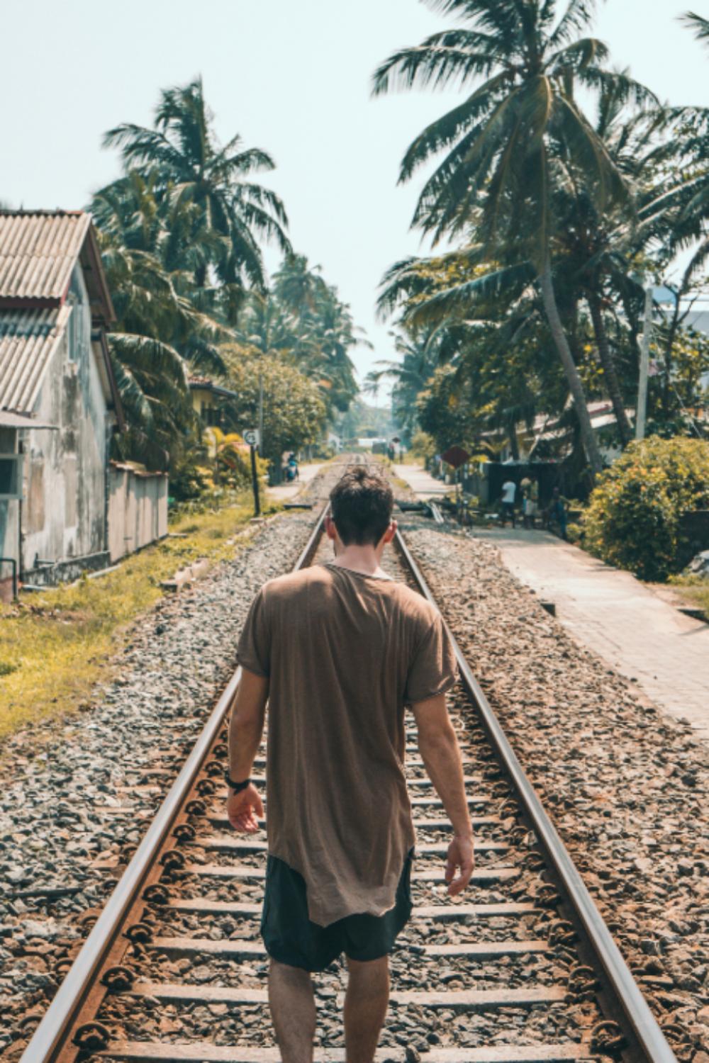 man walking tracks train transport man walking tracks train transport