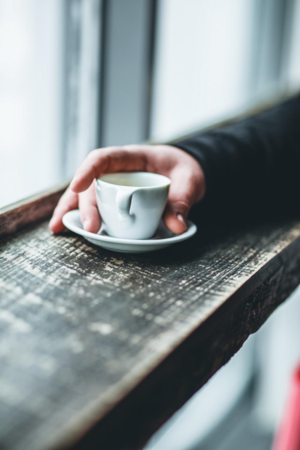man holding espresso coffee cup man holding espresso coffee cup