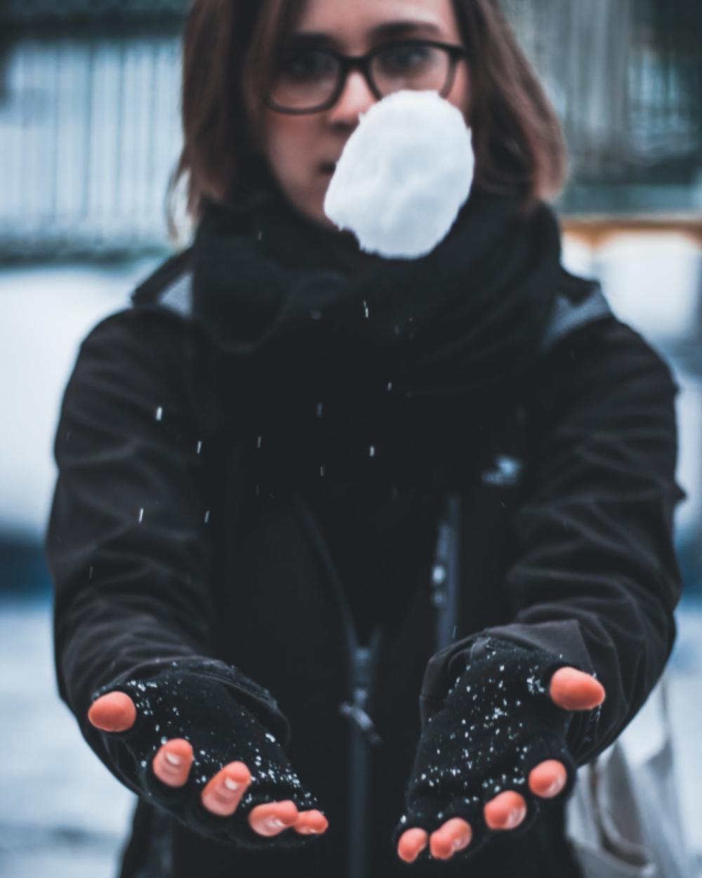 woman catching snowball cold frozen woman catching snowball cold frozen