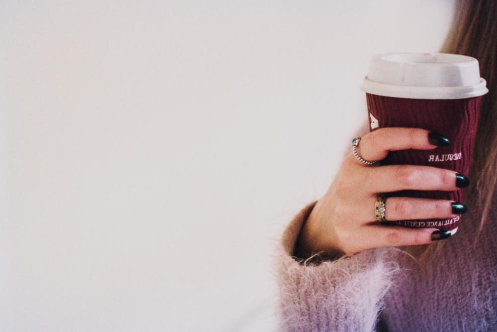 woman holding coffee cup paper woman holding coffee cup paper