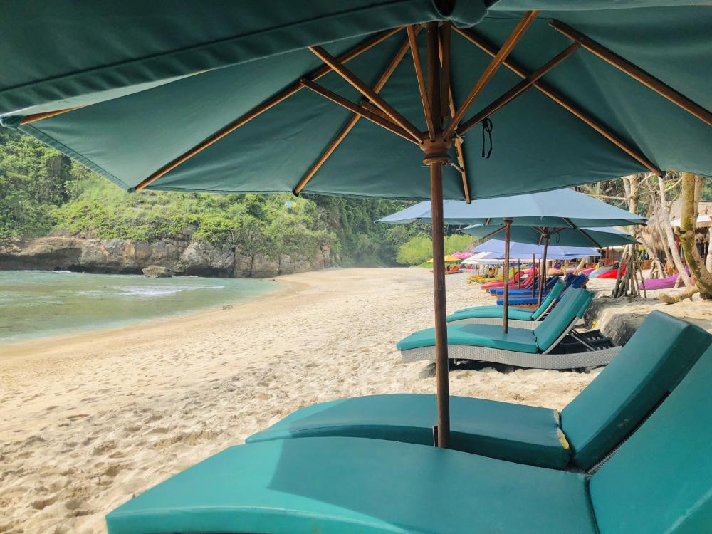 Blue Sun Shades And Deck Chairs On A Golden Sandy Beach Photo Blue Sun Shades And Deck Chairs On A Golden Sandy Beach Photo