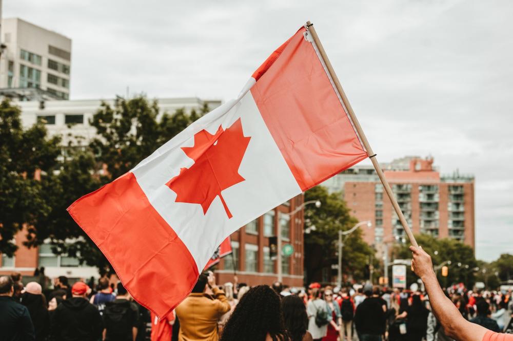 Waving A Canadian Flag Photo Waving A Canadian Flag Photo